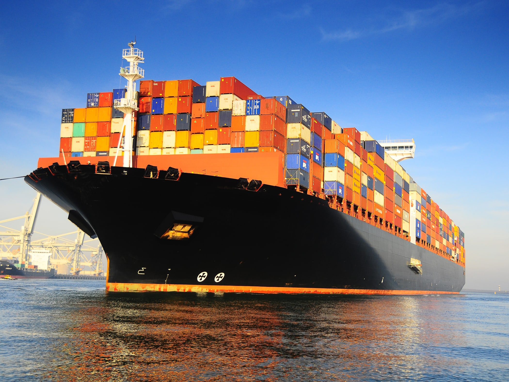 orange black loaded container ship harbour